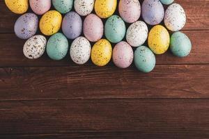 banner. Easter frame with eggs and feathers on a blue wooden background. Minimal concept. View from above. Card with copy space for text. photo