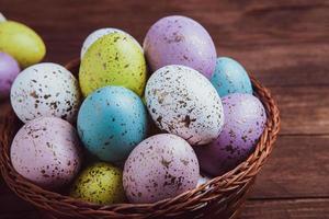 banner. Easter frame with eggs and feathers on a blue wooden background. Minimal concept. View from above. Card with copy space for text. photo