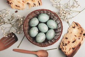 banner. Easter frame with eggs and feathers on a blue wooden background. Minimal concept. View from above. Card with copy space for text. photo