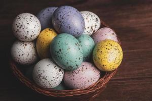 banner. Easter frame with eggs and feathers on a blue wooden background. Minimal concept. View from above. Card with copy space for text. photo