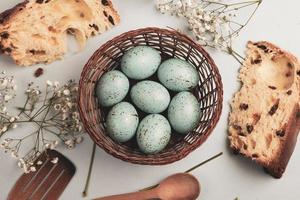 banner. Easter frame with eggs and feathers on a blue wooden background. Minimal concept. View from above. Card with copy space for text. photo