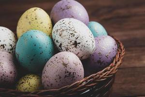 banner. Easter frame with eggs and feathers on a blue wooden background. Minimal concept. View from above. Card with copy space for text. photo