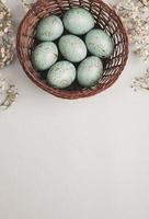 banner. Easter frame with eggs and feathers on a blue wooden background. Minimal concept. View from above. Card with copy space for text. photo
