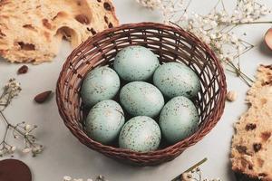 banner. Easter frame with eggs and feathers on a blue wooden background. Minimal concept. View from above. Card with copy space for text. photo