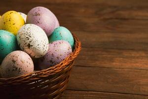 banner. Easter frame with eggs and feathers on a blue wooden background. Minimal concept. View from above. Card with copy space for text. photo