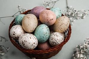 banner. Easter frame with eggs and feathers on a blue wooden background. Minimal concept. View from above. Card with copy space for text. photo