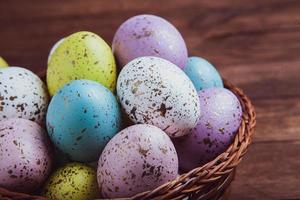 banner. Easter frame with eggs and feathers on a blue wooden background. Minimal concept. View from above. Card with copy space for text. photo