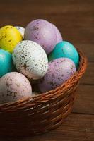 banner. Easter frame with eggs and feathers on a blue wooden background. Minimal concept. View from above. Card with copy space for text. photo