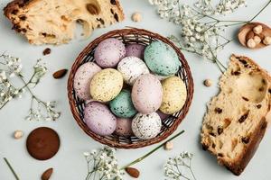 banner. Easter frame with eggs and feathers on a blue wooden background. Minimal concept. View from above. Card with copy space for text. photo