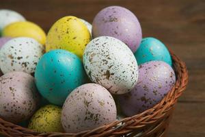 banner. Easter frame with eggs and feathers on a blue wooden background. Minimal concept. View from above. Card with copy space for text. photo