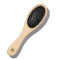 Wooden hairbrush on a white isolated background, top view photo