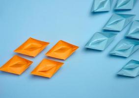 Two groups of paper boats facing each other, a concept of confrontation photo