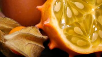 Exotic fruits close-up on a black background rotates video