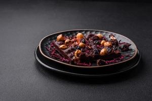 Handmade chocolate with berries, nuts and spices on a dark background photo