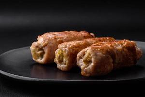 Delicious baked pork or chicken roll with mushrooms, spices and herbs inside photo