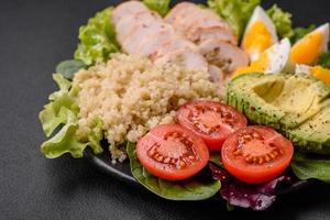 Delicious healthy lunch consisting of chicken, avocado, quinoa, eggs and tomatoes photo