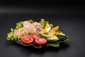 Delicious healthy lunch consisting of chicken, avocado, quinoa, eggs and tomatoes photo