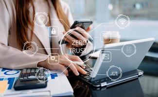 Zero trust security concept Person using computer and tablet with zero trust icon on virtual screen of Data businesses.in office photo