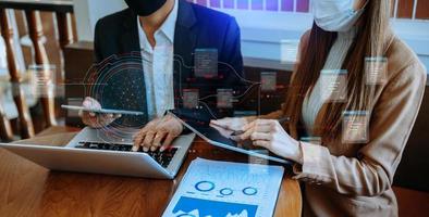 Businessman hand Project manager working and update tasks and Gantt chart scheduling virtual diagram.with smart phone, tablet and laptop in office. photo
