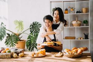 Image of newlywed couple cooking at home. Asia young couple cooking together with Bread and fruit in cozy kitchen in home photo