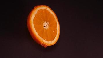 Flüssigkeit Honig fließt Nieder langsam von ein Orange Ring auf ein schwarz Hintergrund video