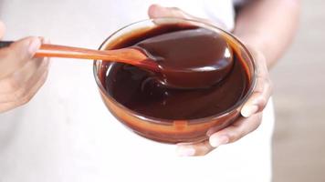 Holding a dark chocolate cream bowl video