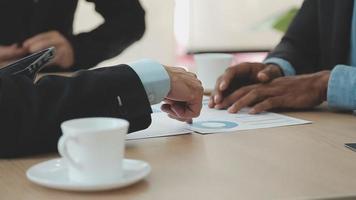 Financial analysts analyze business financial reports on a digital tablet planning investment project during a discussion at a meeting of corporate showing the results of their successful teamwork. video