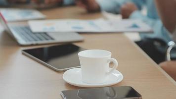 Financial analysts analyze business financial reports on a digital tablet planning investment project during a discussion at a meeting of corporate showing the results of their successful teamwork. video