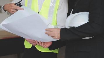 architect man working with laptop and blueprints,engineer inspection in workplace for architectural plan,sketching a construction project ,selective focus,Business concept vintage color video