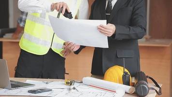 architect man working with laptop and blueprints,engineer inspection in workplace for architectural plan,sketching a construction project ,selective focus,Business concept vintage color video