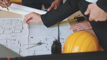 architect man working with laptop and blueprints,engineer inspection in workplace for architectural plan,sketching a construction project ,selective focus,Business concept vintage color video