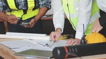 architect man working with laptop and blueprints,engineer inspection in workplace for architectural plan,sketching a construction project ,selective focus,Business concept vintage color video