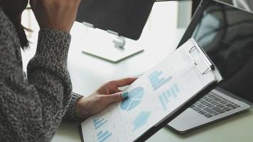 Financial Business team present. Business man hands hold documents with financial statistic stock photo, discussion, and analysis report data the charts and graphs. Finance Financial concept video