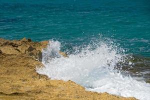 waves on lava rocks photo