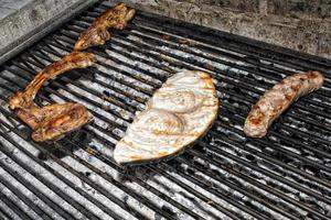 fish and meat on barbecue photo