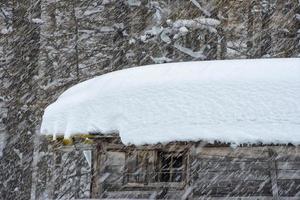 mountain hut under the snow photo