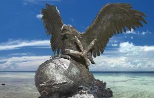 American Eagle bronze sculpture on tropical paradise background photo