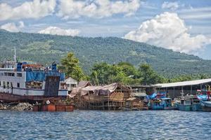 rusty rugged ship in indonesia harbor photo