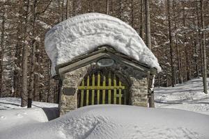 pequeño montaña capilla en nieve antecedentes invierno hora foto