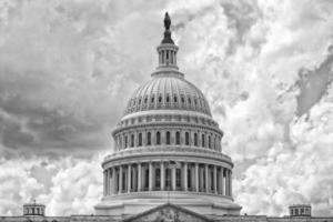 Washington DC Capitol on cloudy sky in black and white photo