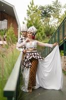 a couple in white clothes posing very intimately and intimately in a park photo