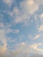 Beautiful white clouds on deep blue sky background. Large bright soft fluffy clouds are cover the entire blue sky. photo