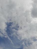 Beautiful white clouds on deep blue sky background. Large bright soft fluffy clouds are cover the entire blue sky. photo