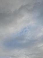 Beautiful white clouds on deep blue sky background. Large bright soft fluffy clouds are cover the entire blue sky. photo