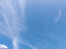 Beautiful white clouds on deep blue sky background. Large bright soft fluffy clouds are cover the entire blue sky. photo