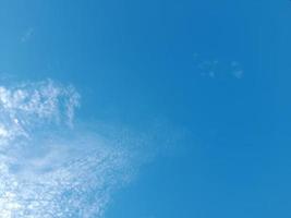 Beautiful white clouds on deep blue sky background. Large bright soft fluffy clouds are cover the entire blue sky. photo