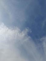 Beautiful white clouds on deep blue sky background. Large bright soft fluffy clouds are cover the entire blue sky. photo