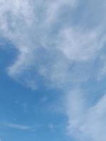 Beautiful white clouds on deep blue sky background. Large bright soft fluffy clouds are cover the entire blue sky. photo