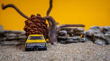 toy car hauling pinecones on an orange background photo