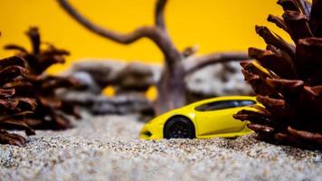 Minahasa, Indonesia saturday, December 2022, a toy car among the pinecones photo